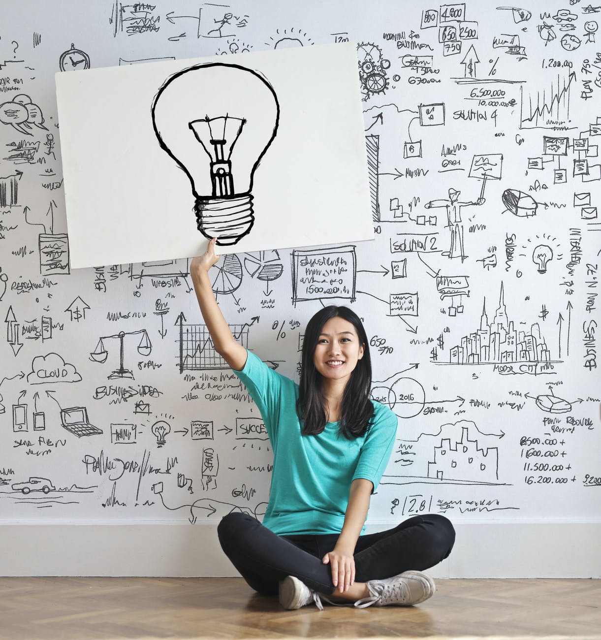 ragazza-tiene-cartello-con-immagine-lampadina-idea